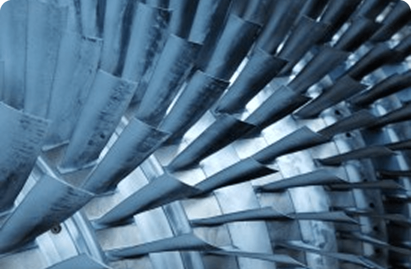 Close-up view of turbine blades inside an industrial gas or jet engine, showcasing precision engineering and aerodynamic design.