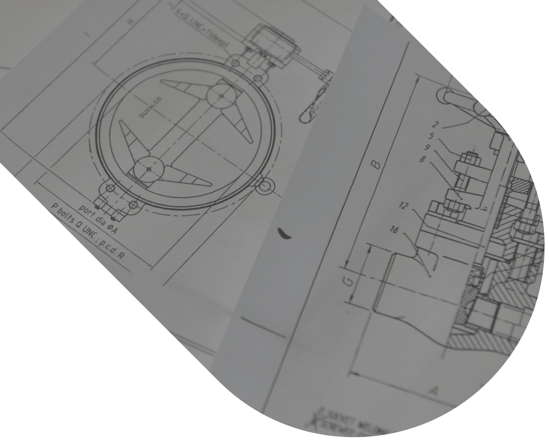 Close-up of technical engineering drawings showing mechanical component schematics with precise measurements and annotations.